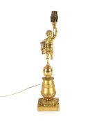 An Ormolu table lamp, in the form of a putti with lyre stood on a ball above foliate column and
