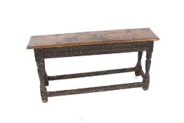An 18th Century long joint stool having carved fri