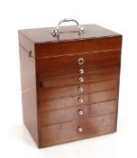 A 20th Century mahogany cased dentist's cabinet, fitted lifting top compartment and six drawers