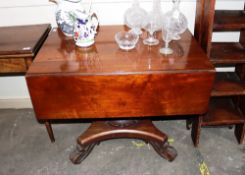 A 19th Century mahogany drop leaf supper table, raised on a baluster turned column and quatrefoil