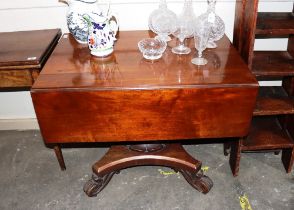 A 19th Century mahogany drop leaf supper table, raised on a baluster turned column and quatrefoil