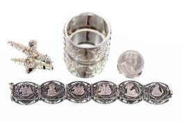 A white metal napkin ring, with foliate and stylised decoration; an Eastern filigree work bracelet