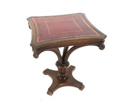 A Georgian style mahogany centre table, with leather inset top raised on carved foliate scrolled