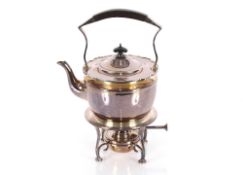 A plated tea kettle on spirit heater stand having angular black wood mounted handle