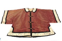 An antique Chinese silk finely embroidered robe with old overstitch repairs to the plain ground,