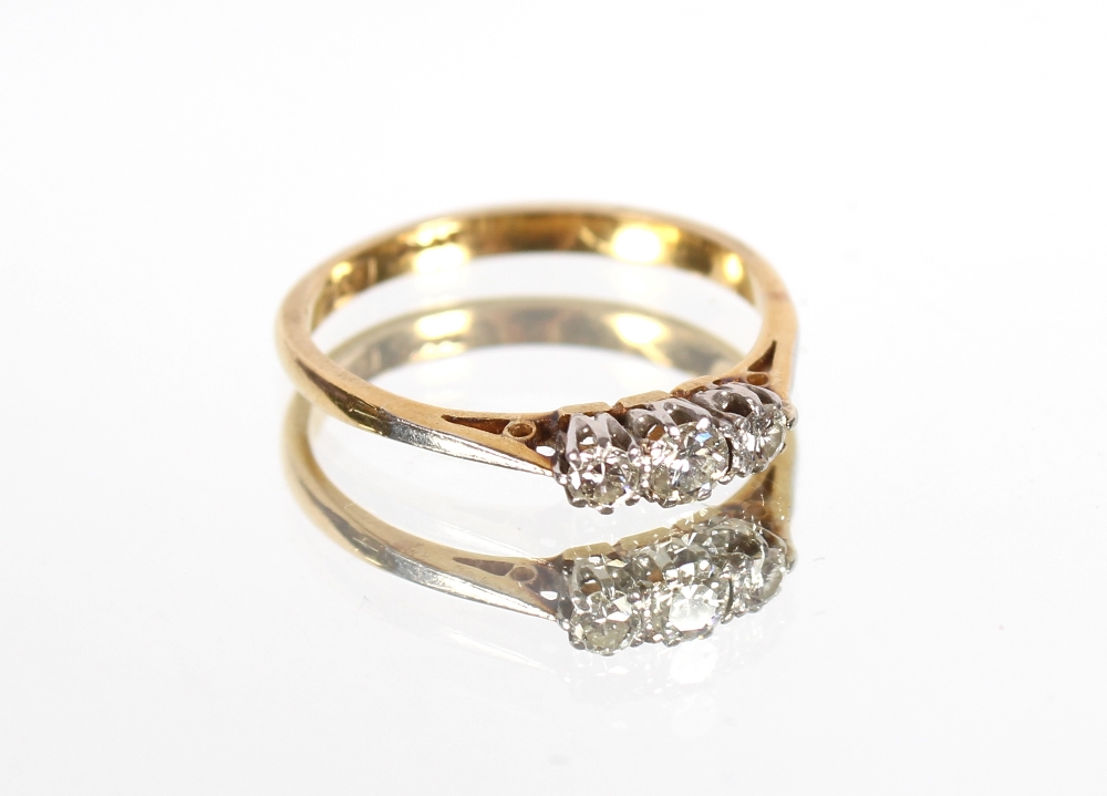 An 18ct gold and platinum three stone diamond ring