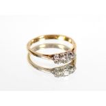 An 18ct gold and platinum three stone diamond ring