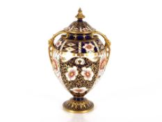 A Royal Crown Derby Imari pattern baluster vase and cover, heightened in gilt, 30cm high AF ; and