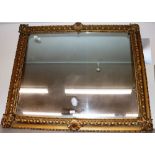 A large gilt framed over mantel mirror with foliat