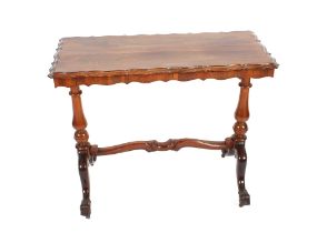 A Victorian rosewood occasional table, raised on turned baluster columns united by a cross