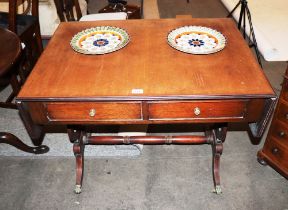 A 19th Century mahogany sofa table, fitted drop leaves, two short drawers raised on lyre end