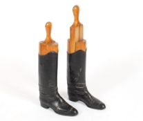 A pair of antique leather riding boots, complete with wooden boot trees