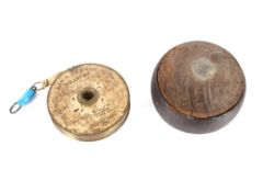 A vintage iron rimmed bowling wood; and a lawn tennis tape measure