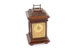 A 19th Century Symphonion musical clock, in walnut case fitted brass carrying handle, 38cm high