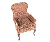 An early 20th Century mahogany framed armchair, floral upholstery raised on cabriole front supports