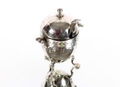 An unusual silver mustard pot of egg coddler form, ornate floral engraving to the exterior, raised