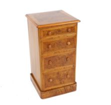 A pair of walnut herringbone and cross banded bedside chests, fitted four graduated drawers,