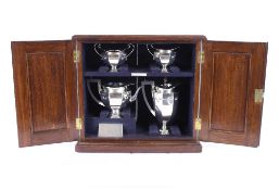 A George V silver four piece tea set, by Roberts & Belk contained in a fitted two door oak case,