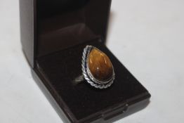 A white metal and Tigers Eye stone set ring