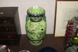 An Oriental green glazed vase with floral and pier