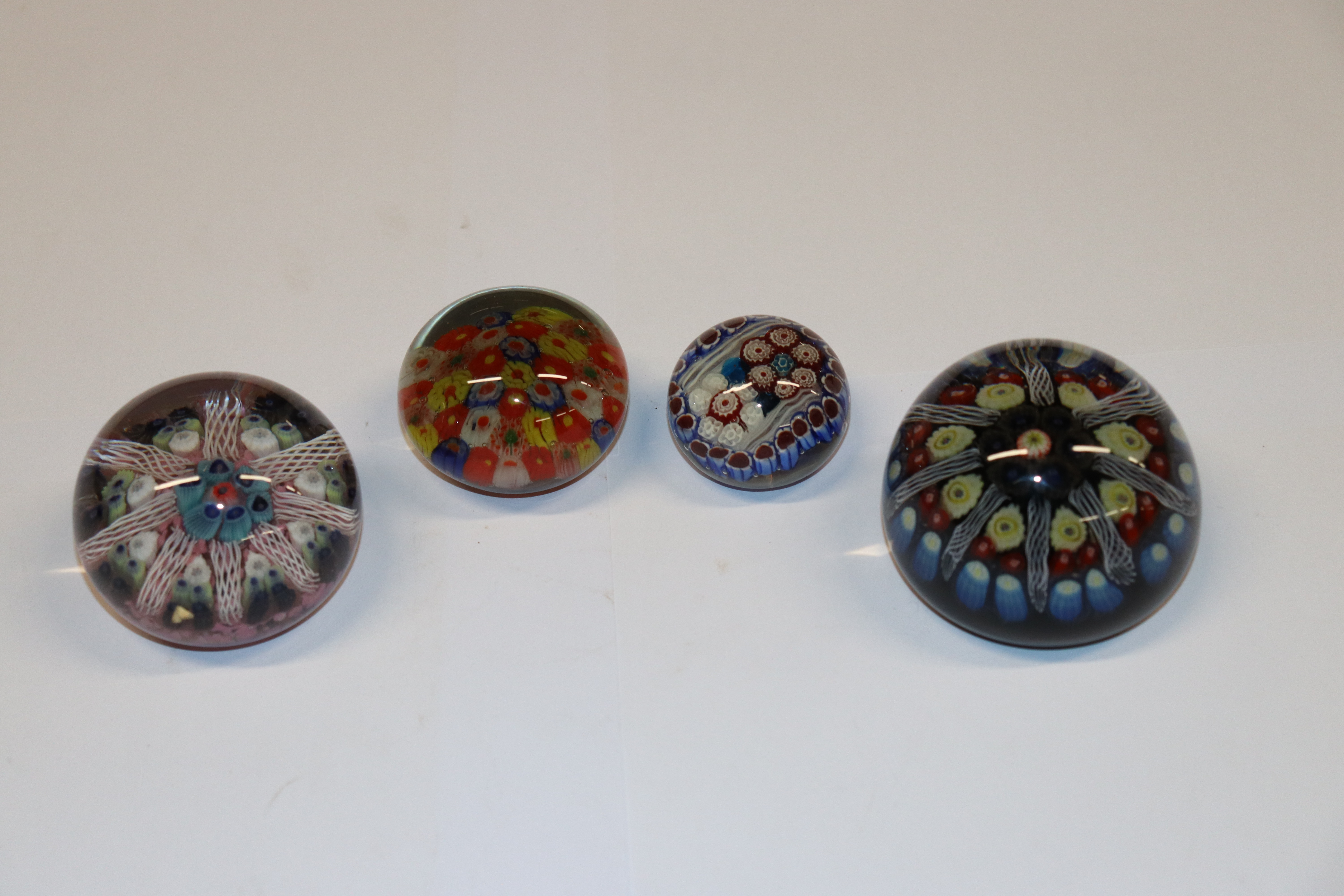 Four Millefiori glass paperweights