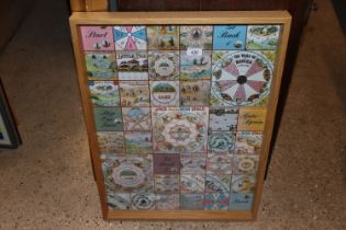 A glazed Nursery games poster in light oak frame