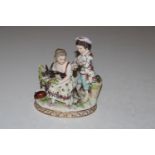 A Dresden porcelain group depicting two children and a goat