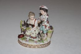A Dresden porcelain group depicting two children and a goat