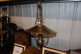 A brass oil hanging lamp with glass chimney