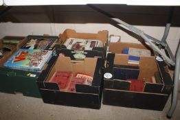Six boxes containing various annuals, vintage car