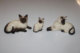 Two Royal Doulton models of Siamese cats and a Bes