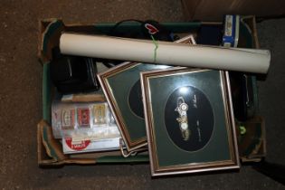 A box containing matchbox covers, cameras, prints