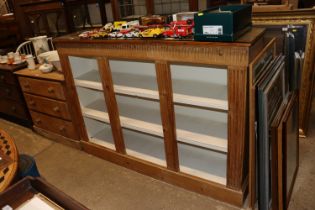 A stripped pine open fronted bookcase with white p