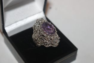 A silver and amethyst set ring