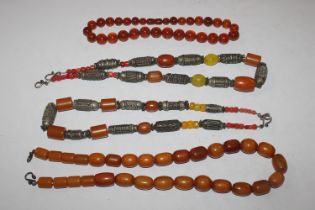 An amber coloured bead necklace; another bead neck