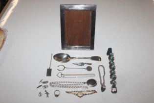 A silver photo frame; a box containing silver spoo