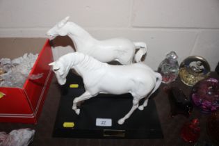 Two Beswick white glazed modelled horses on plinth