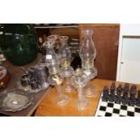 Four glass oil lamps, one lacking chimney