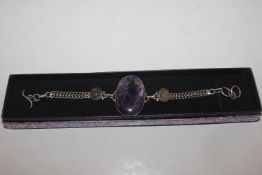 A 925 silver and amethyst coloured bracelet