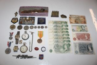 A box containing various coins, bank notes, pocket