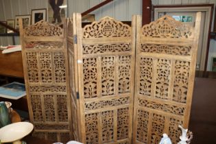 An Eastern carved four panel screen