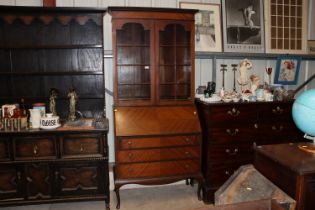 A 1920's glazed mahogany bureau bookcase, upper section having three adjustable shelves, lower