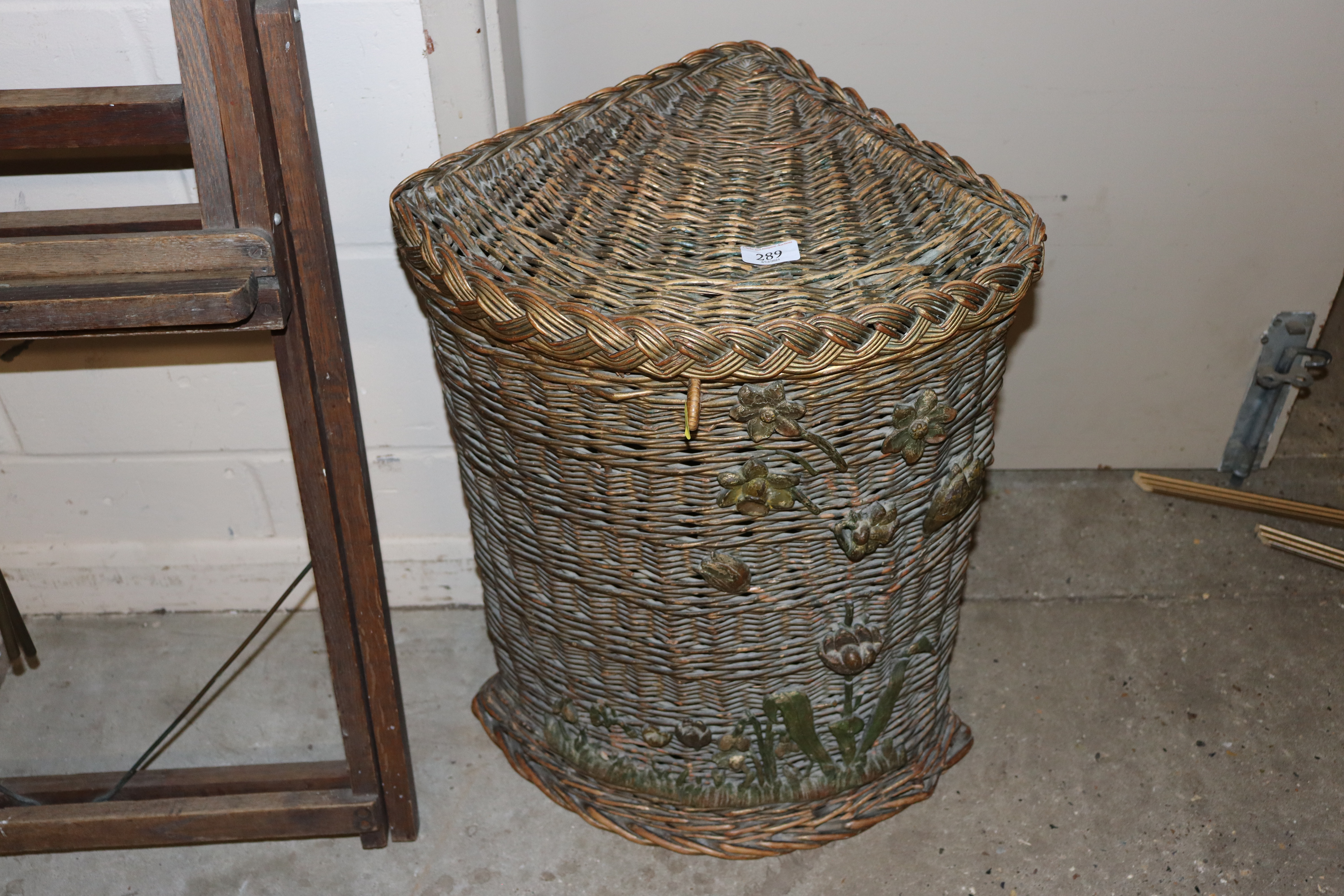 A wicker corner basket with applied carved wood de