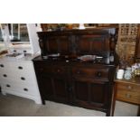 An oak court cupboard fitted two drawers, raised o