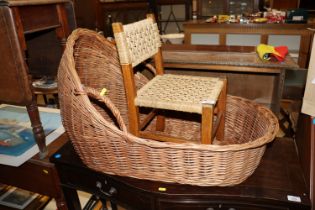 A wicker carrying crib and a child's string seated