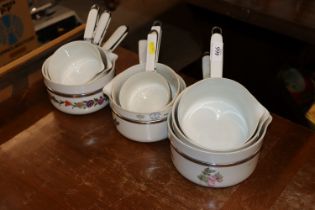 Nine French floral decorated saucepans