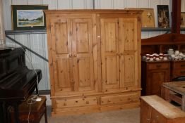A pine double wardrobe fitted two drawers below