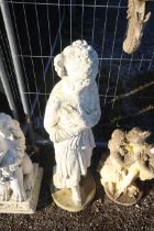 A white painted concrete garden statue in the form of a maiden