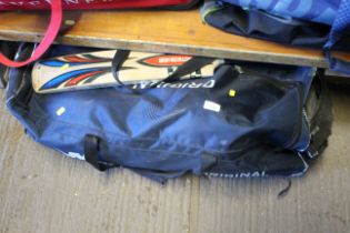 A cricket holdall and contents of cricket equipmen