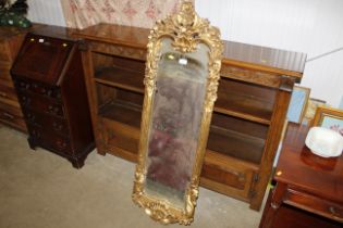 An ornate gilt framed wall mirror